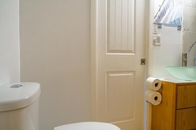 bathroom featuring vanity and toilet