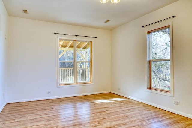 spare room with light hardwood / wood-style flooring