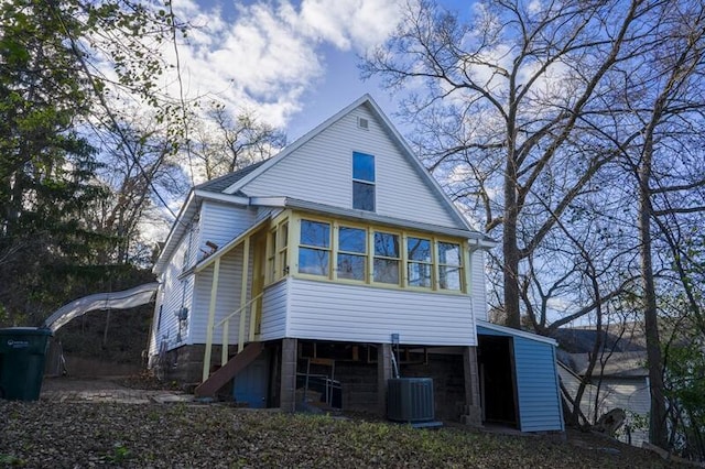 rear view of property with cooling unit