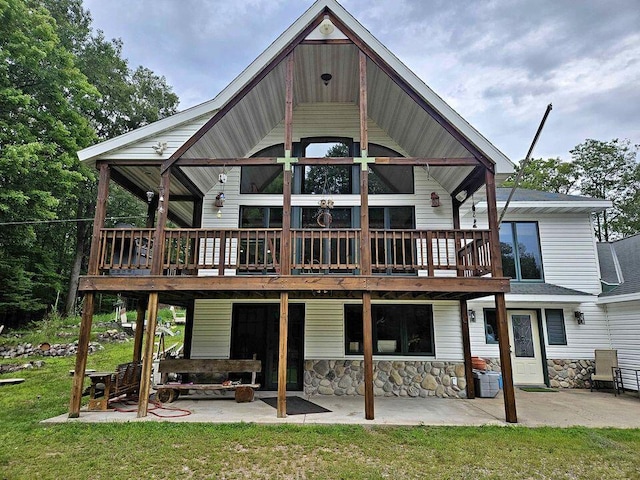 back of property featuring a patio area, a yard, and a deck