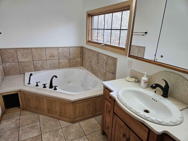 bathroom featuring a bathing tub, tile patterned flooring, and vanity