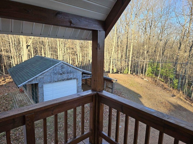 deck featuring an outbuilding and a garage