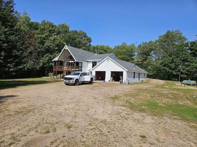 view of front of home featuring a front lawn and a wooden deck