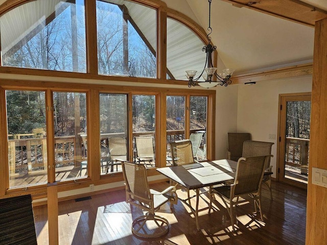 dining room featuring hardwood / wood-style flooring, plenty of natural light, and a notable chandelier