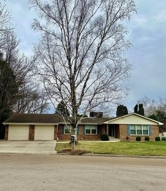 single story home featuring a front yard and a garage