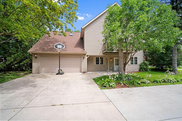 view of front of property with a garage and a front lawn