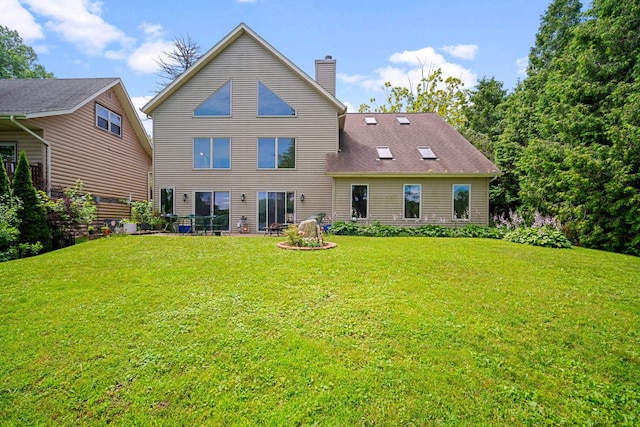 back of house featuring a yard