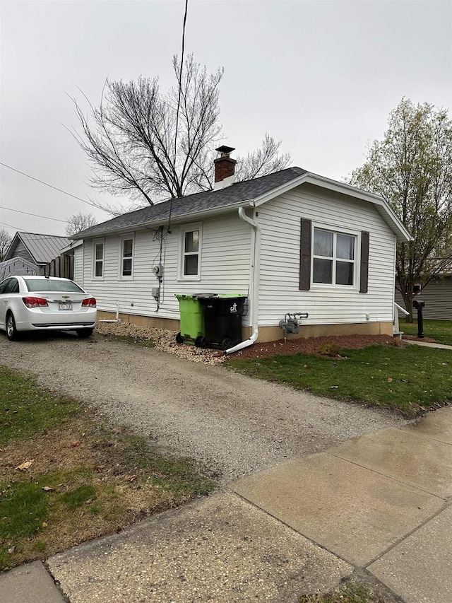 view of side of property with a yard