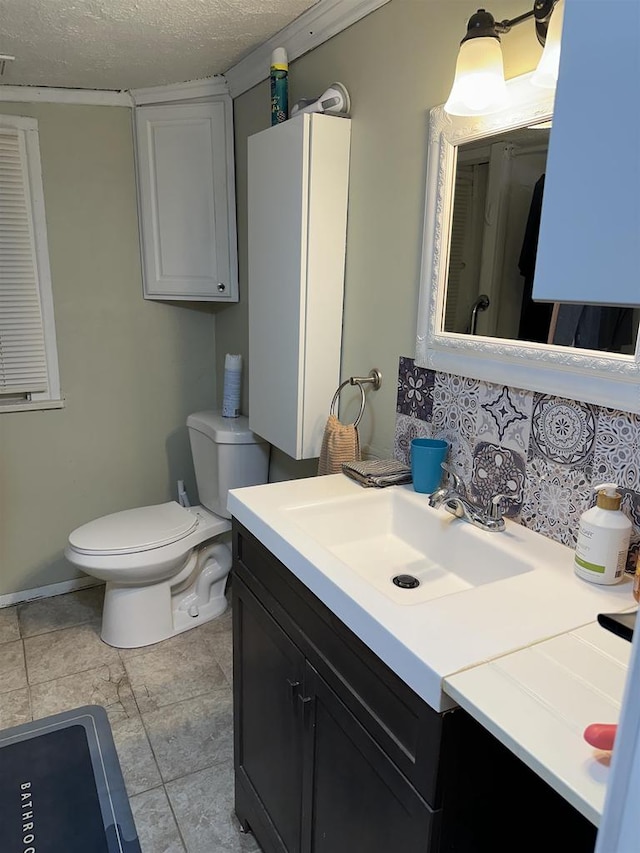 bathroom with tile patterned floors, vanity, toilet, and a textured ceiling