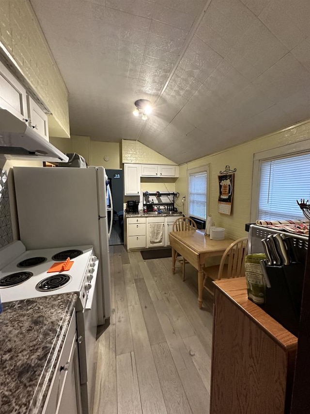 kitchen featuring lofted ceiling, white electric range, light hardwood / wood-style flooring, plenty of natural light, and white cabinetry