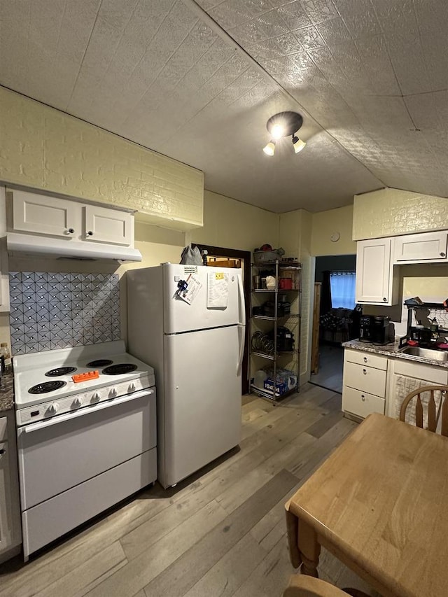 kitchen with white cabinetry, light hardwood / wood-style floors, and white appliances