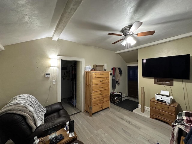 interior space with vaulted ceiling with beams, ceiling fan, and light hardwood / wood-style floors