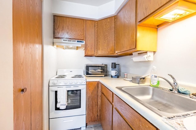 kitchen featuring white range and sink