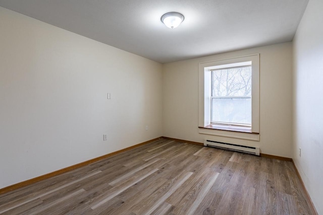 unfurnished room featuring light wood-type flooring and a baseboard radiator