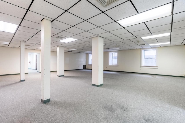 basement with light carpet and a drop ceiling