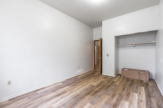 unfurnished bedroom featuring a closet and wood-type flooring