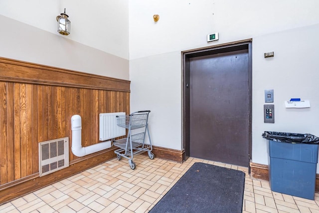 miscellaneous room featuring wooden walls