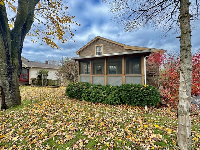 view of side of home with a sunroom