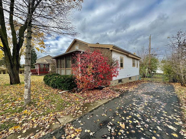 view of home's exterior with a wooden deck