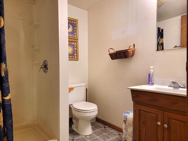 bathroom with tile patterned floors, toilet, vanity, and walk in shower