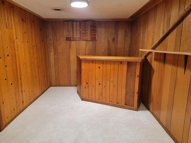 bar with light carpet and wood walls