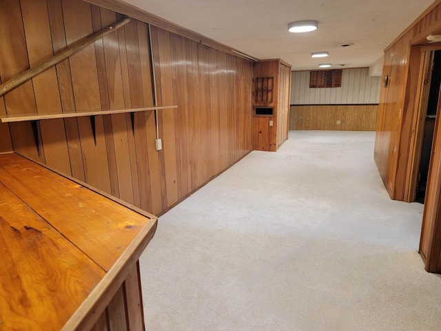 corridor with light carpet and wooden walls