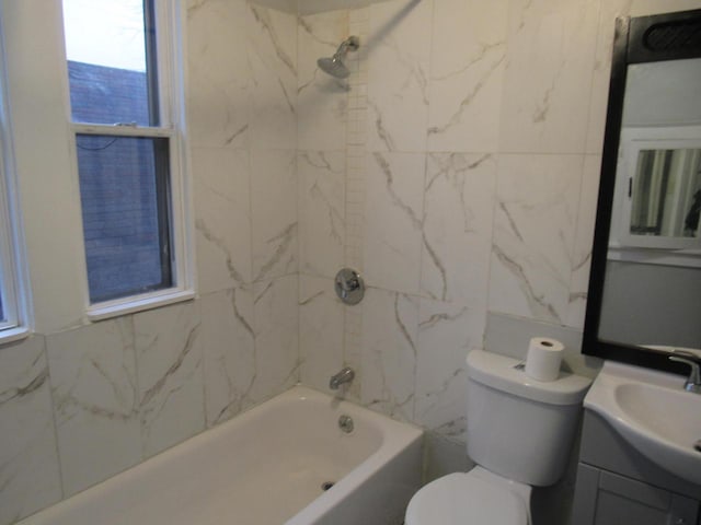 full bathroom featuring toilet, vanity, and tiled shower / bath combo