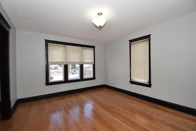 empty room with hardwood / wood-style floors