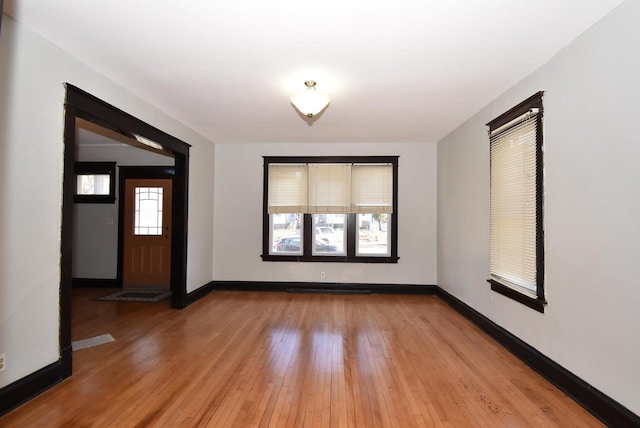 empty room with hardwood / wood-style flooring