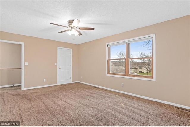 unfurnished bedroom with ceiling fan, carpet, and a textured ceiling