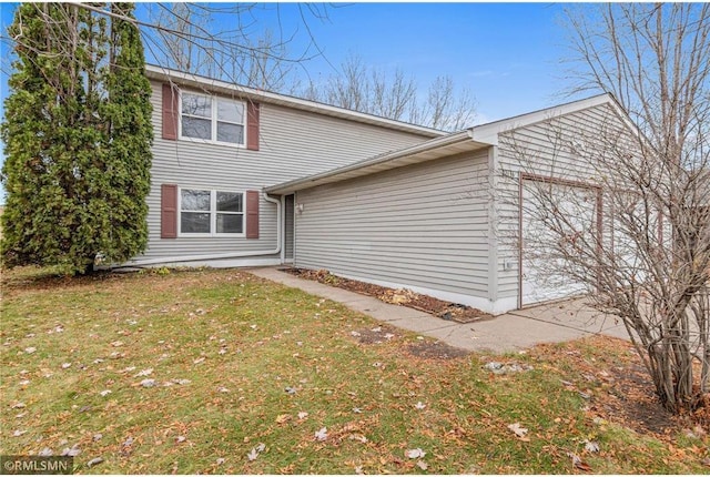 view of side of home featuring a lawn