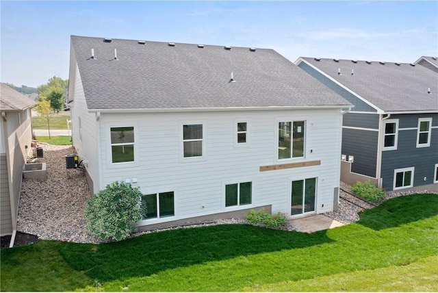 back of house with a lawn, central AC, and a patio area