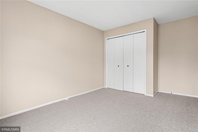 unfurnished bedroom featuring a closet and carpet