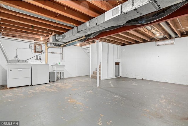 basement featuring washer and dryer and sink