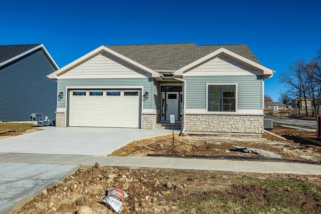 craftsman house featuring central AC and a garage