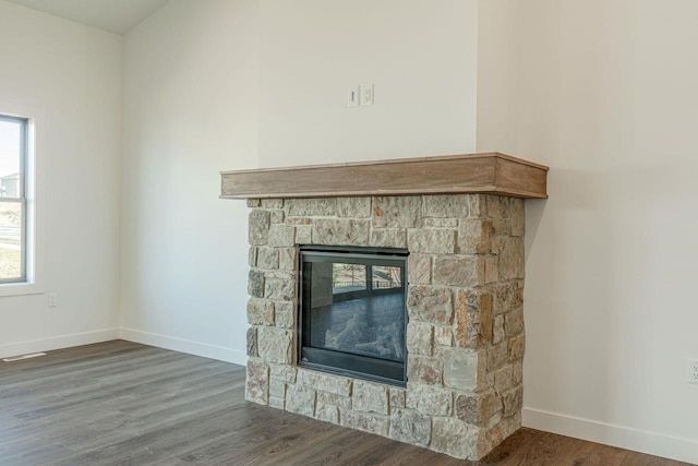 interior details with a fireplace and wood-type flooring