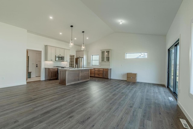 kitchen featuring a large island, hanging light fixtures, dark hardwood / wood-style floors, white cabinets, and appliances with stainless steel finishes