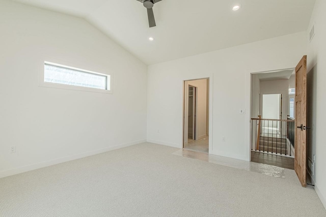 interior space featuring a spacious closet, lofted ceiling, ceiling fan, and carpet floors