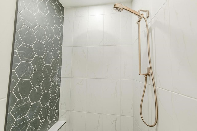 bathroom with tiled shower