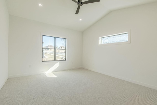 carpeted empty room featuring vaulted ceiling and ceiling fan