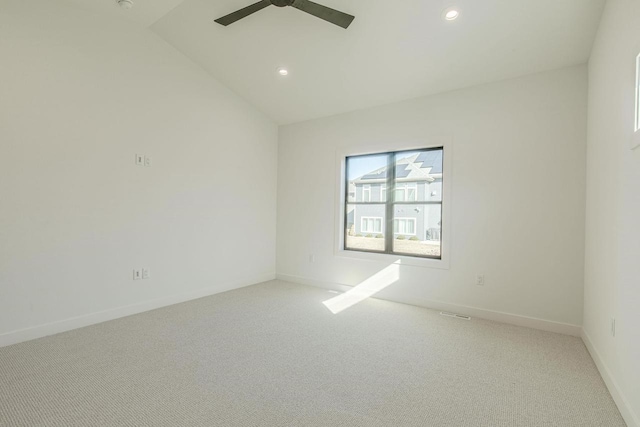 unfurnished room with ceiling fan, light colored carpet, and vaulted ceiling