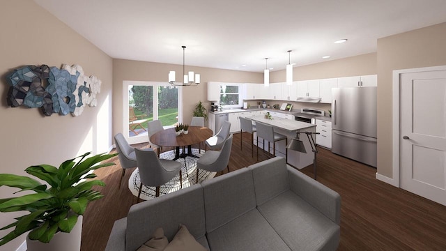 dining area with dark hardwood / wood-style flooring and an inviting chandelier