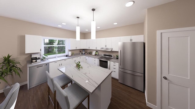 kitchen featuring dark wood-type flooring, hanging light fixtures, a kitchen island, white cabinets, and appliances with stainless steel finishes