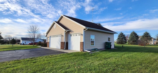 view of side of property with a lawn and a garage