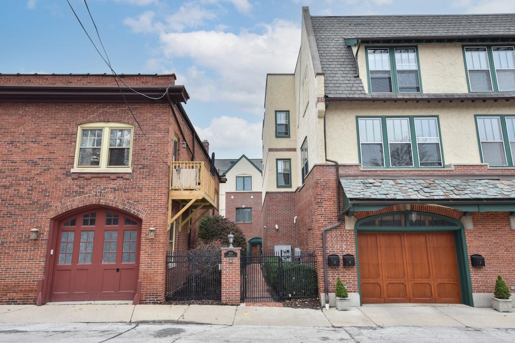 view of front of property featuring a garage and a balcony