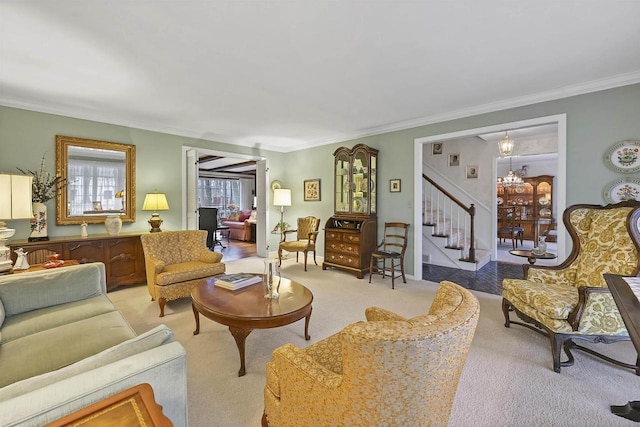 carpeted living room with ornamental molding and a notable chandelier