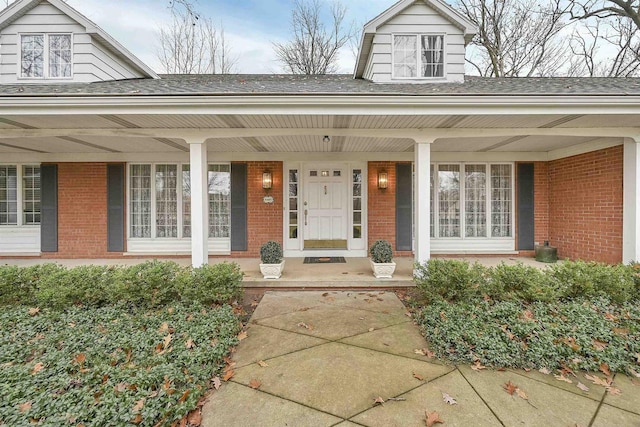 view of exterior entry featuring a porch