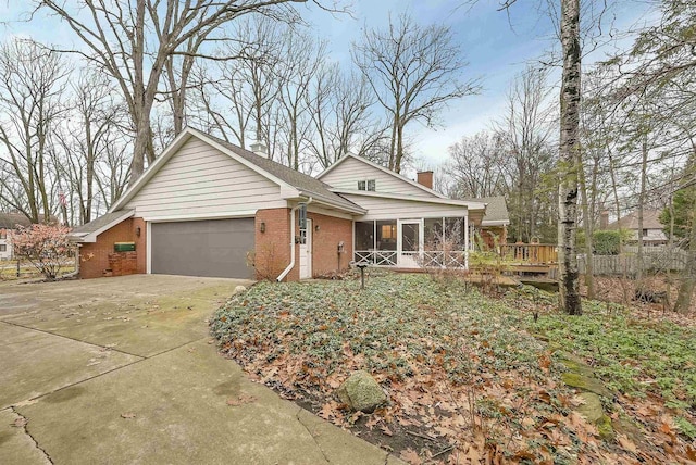 single story home with a sunroom and a garage