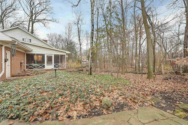 view of yard featuring a sunroom