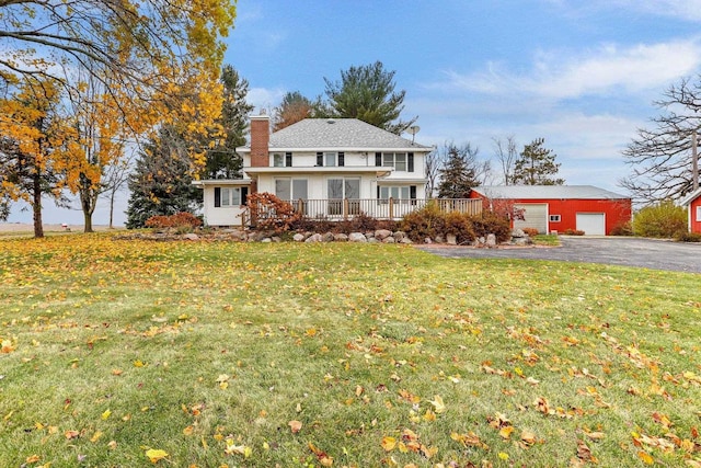 view of property with covered porch, a front yard, and a garage